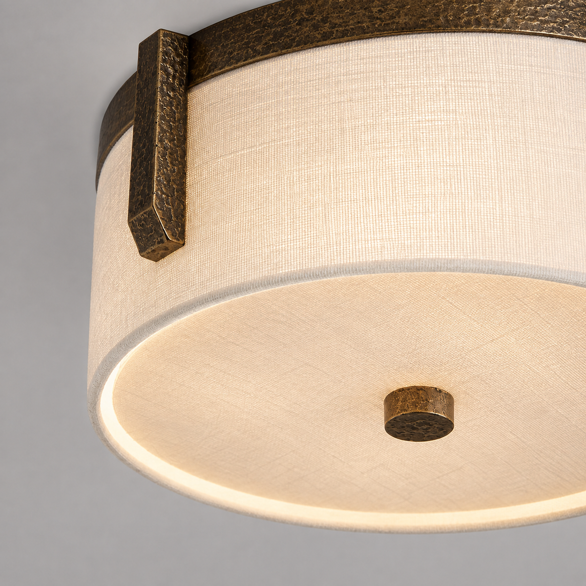 Underside of the Linnea linen flush mount with the white diffuser and brass center finial