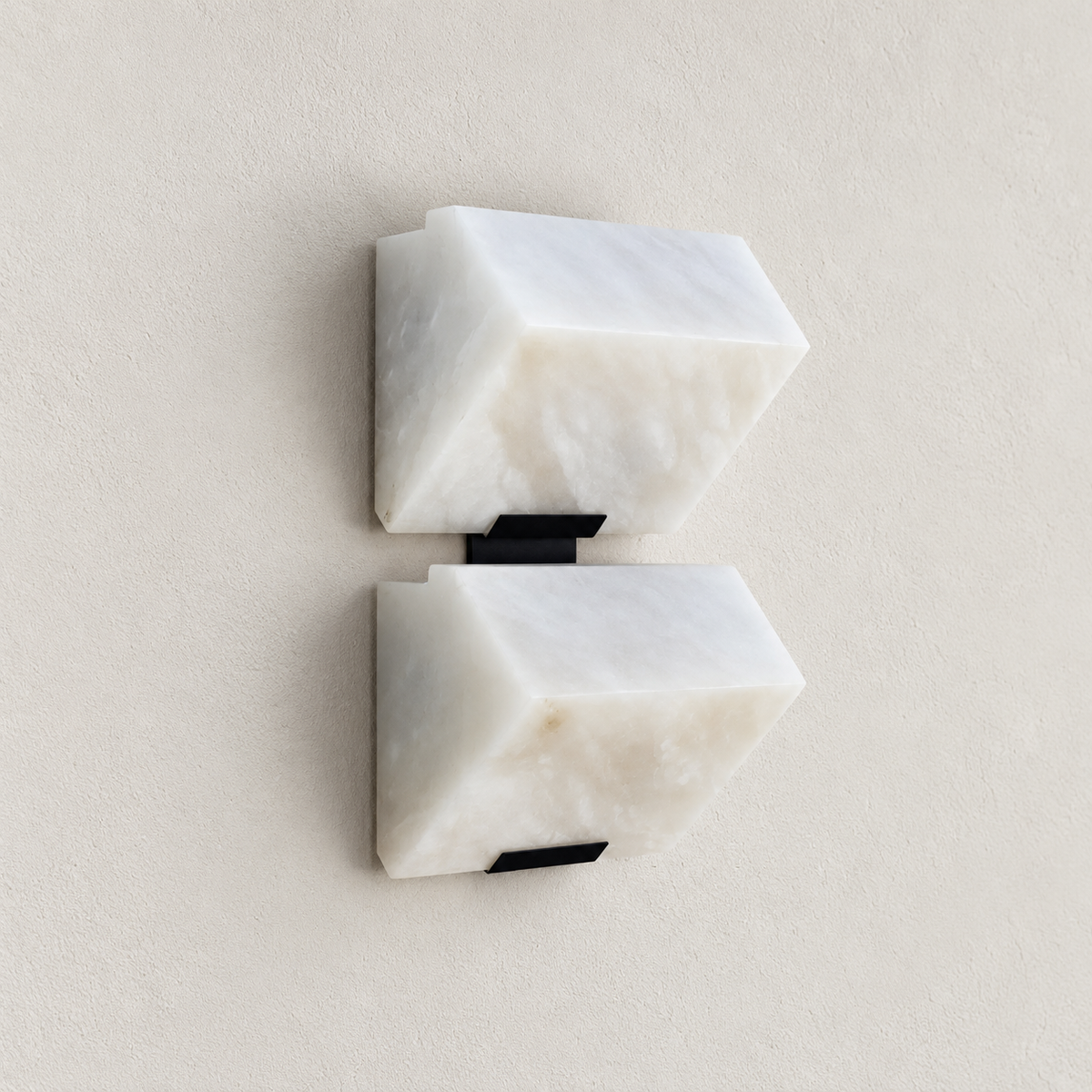 Double alabaster block wall sconce viewed at an angle.