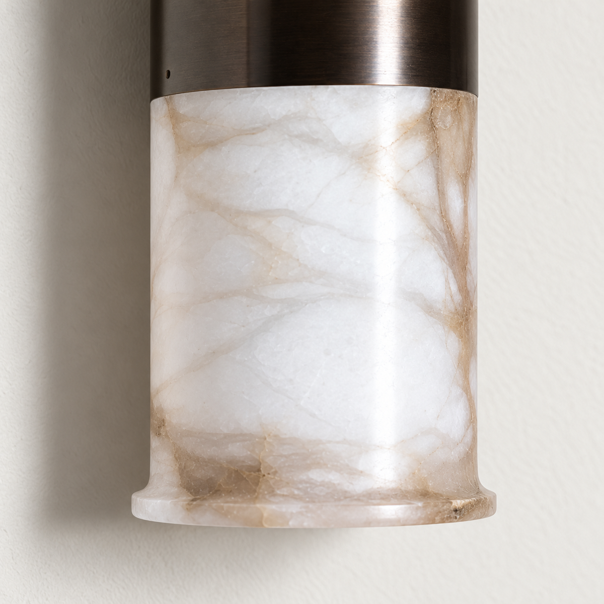 Detail of the alabaster cylinder and dark bronze sleeve.