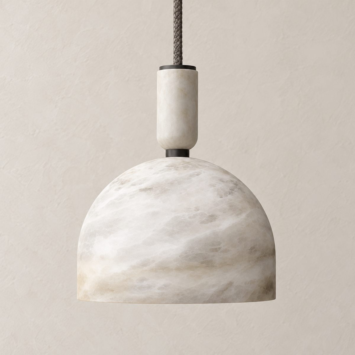 Alabaster dome pendant with honed stone cap and fabric cable, unlit.