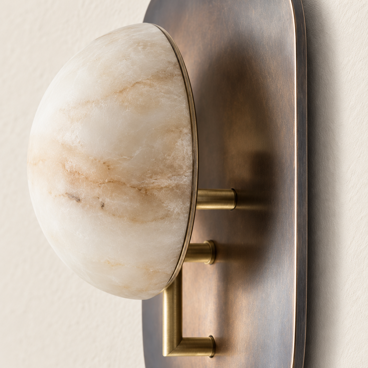 Detail of the alabaster half-dome, brass supports and patinated shield.