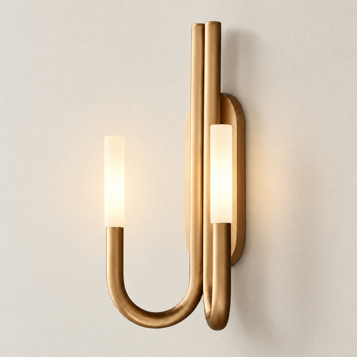 Brass double-arm sconce with both frosted shades illuminated.