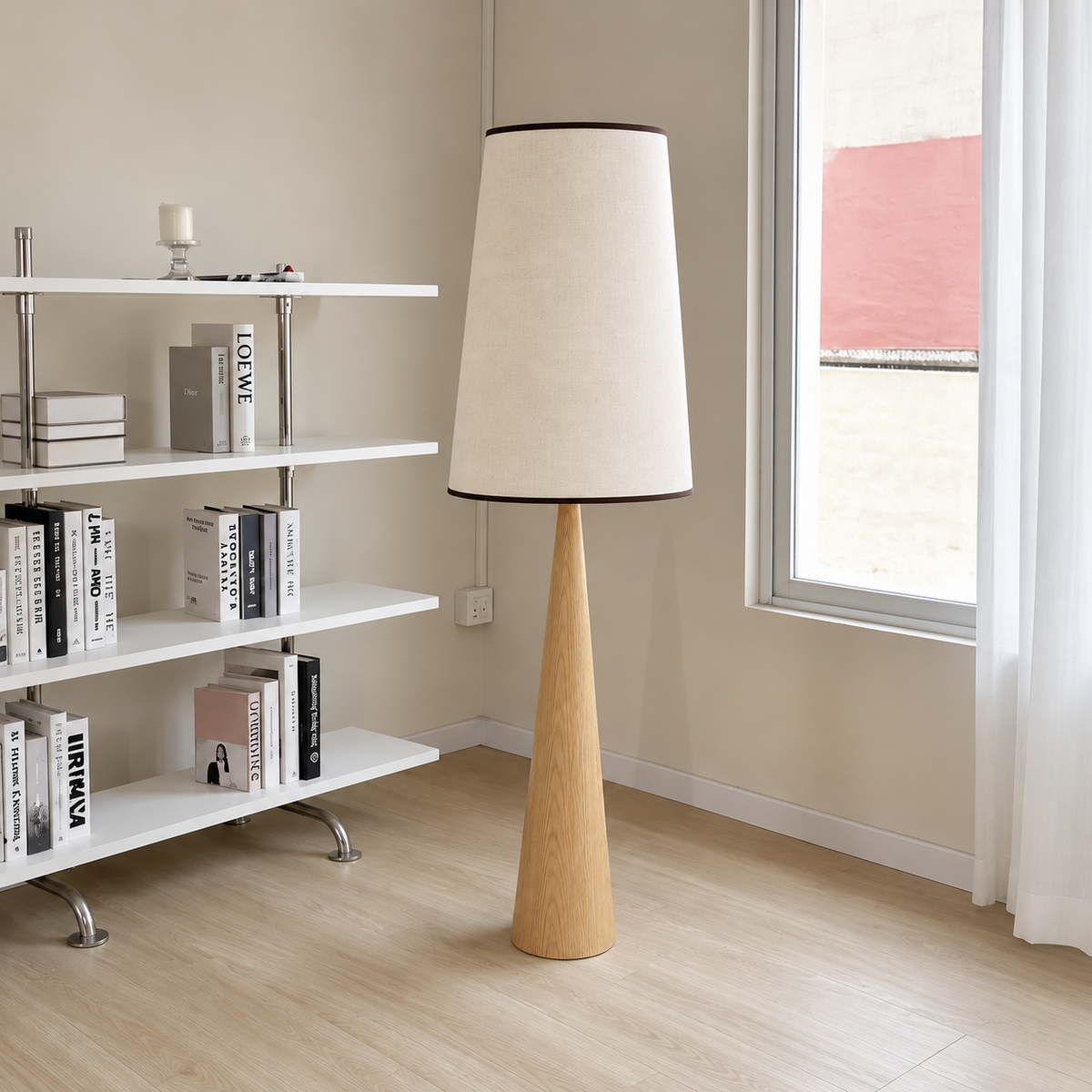 Ash CLBAK floor lamp beside white bookshelves and a tall window.