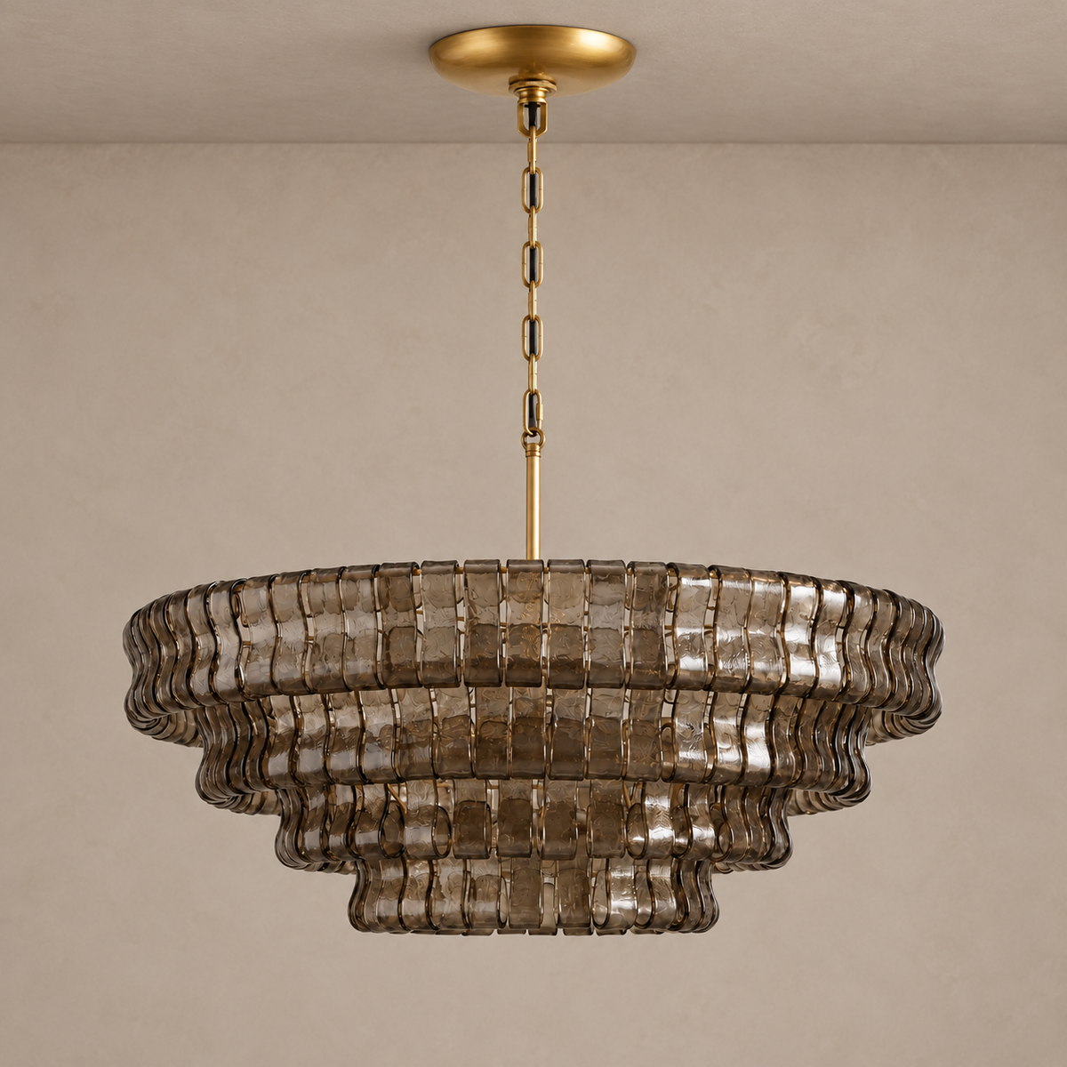 Round Bellatrix chandelier with tiered smoky brown glass and brass suspension, unlit.
