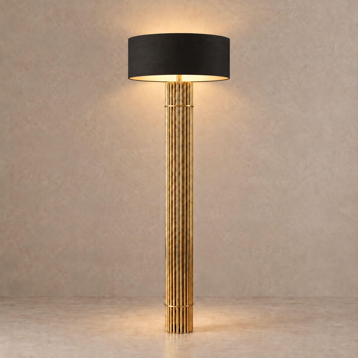 Black 55 cm drum shade lit above the fluted brass floor-lamp column.