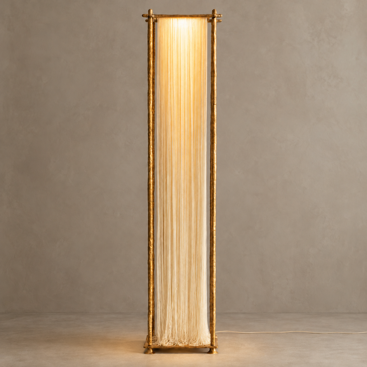 Cascade floor lamp illuminated, with warm light filtering down its long ivory silk strands.