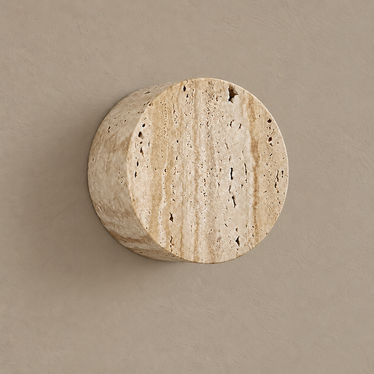 Bonetti travertine cylinder wall light, unlit on a stone-beige wall