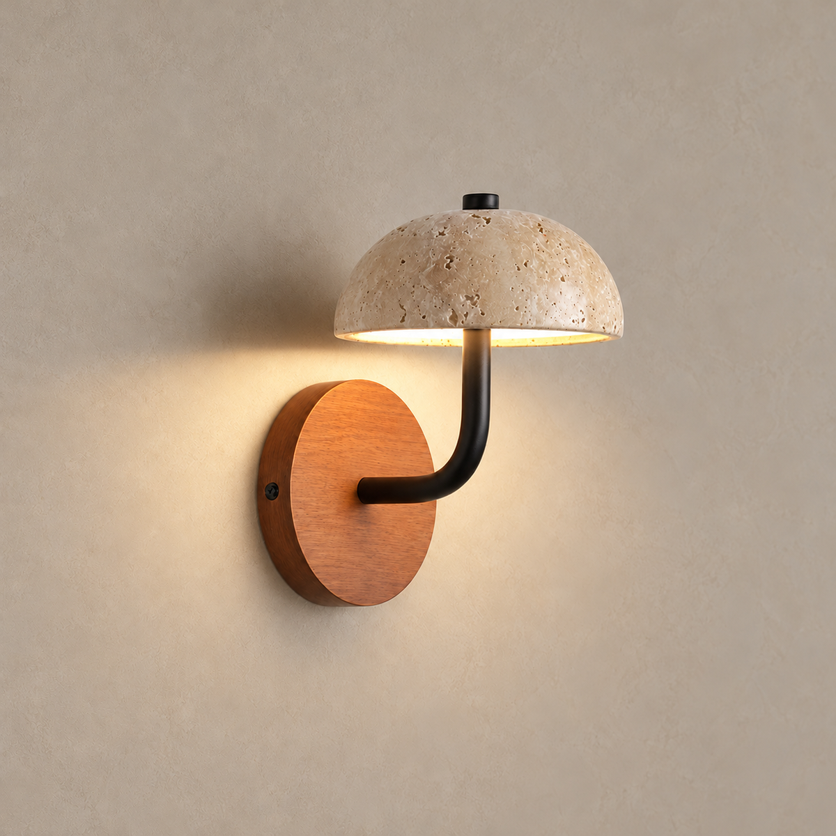 Travertine dome wall light illuminated beneath the stone shade.