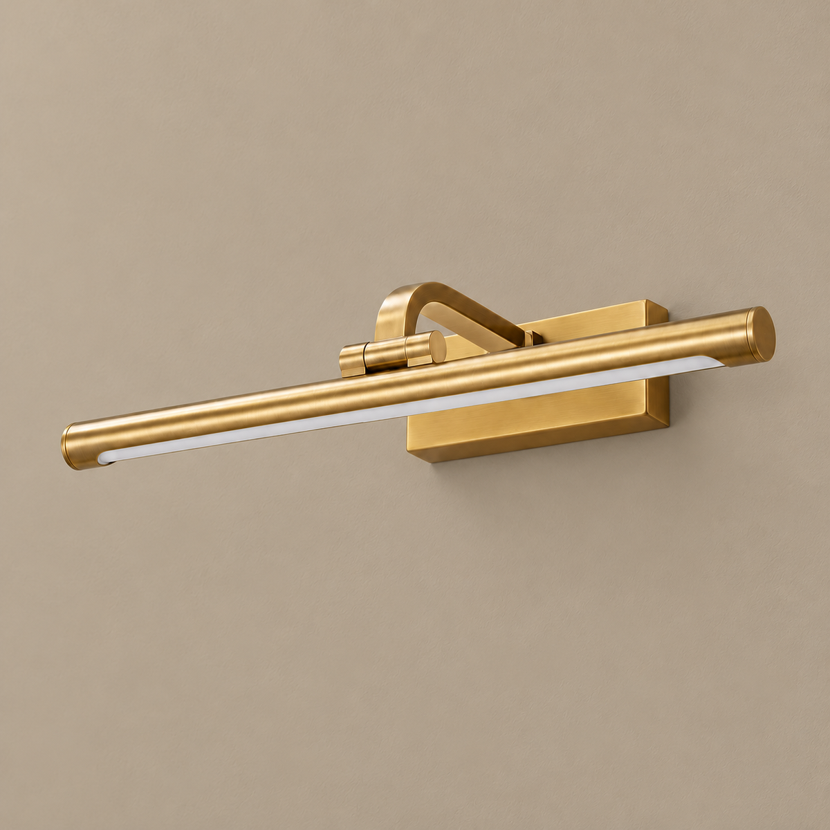 Brass linear LED picture light, unlit on a stone-beige wall