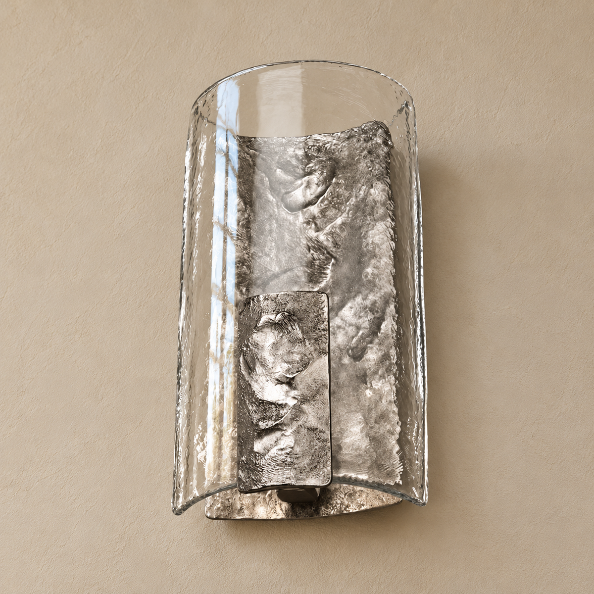 Low-angle view of the silver wall sconce showing the open glass rim, rough metal interior and projecting front shield.