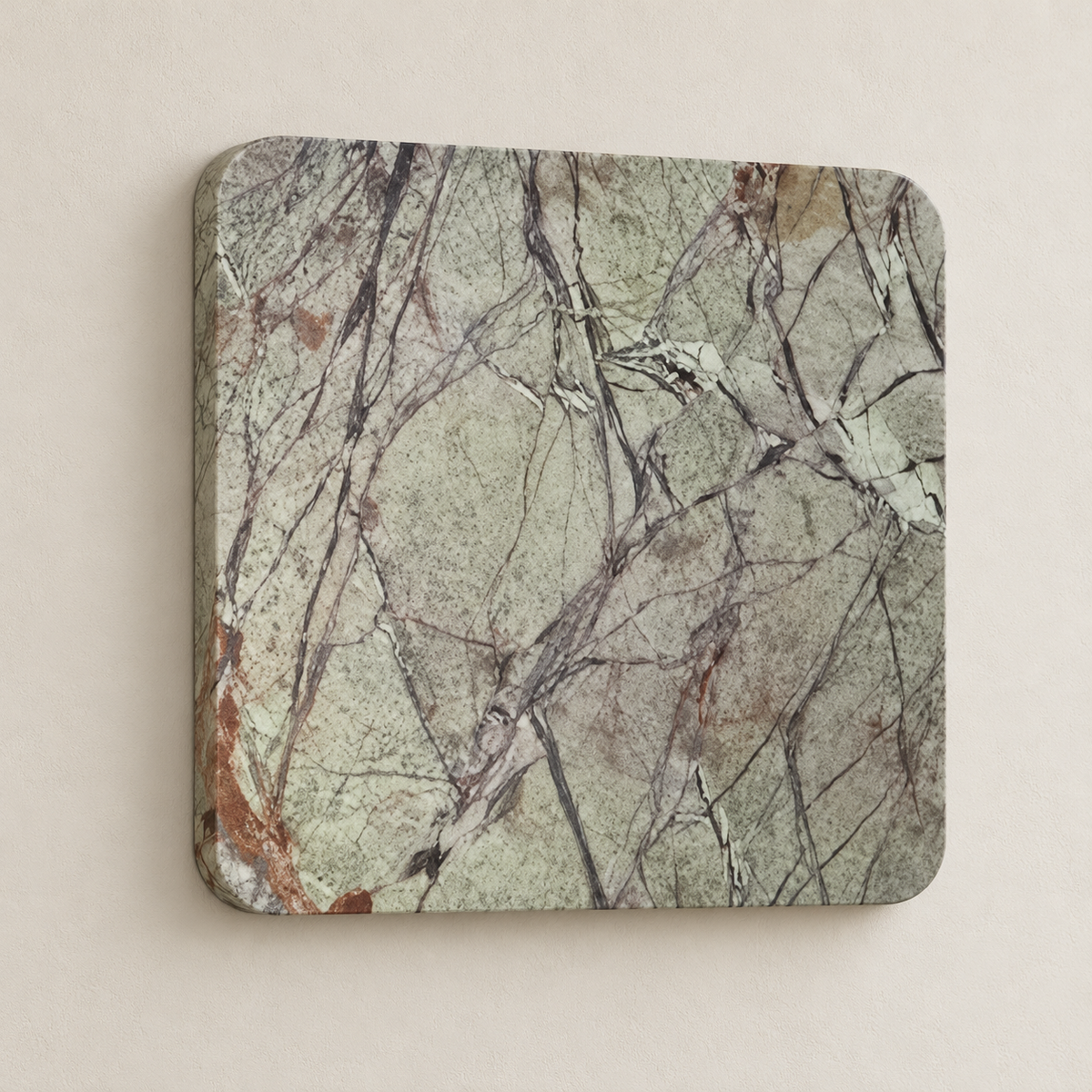 Oblique view of the green marble square wall light on beige plaster.