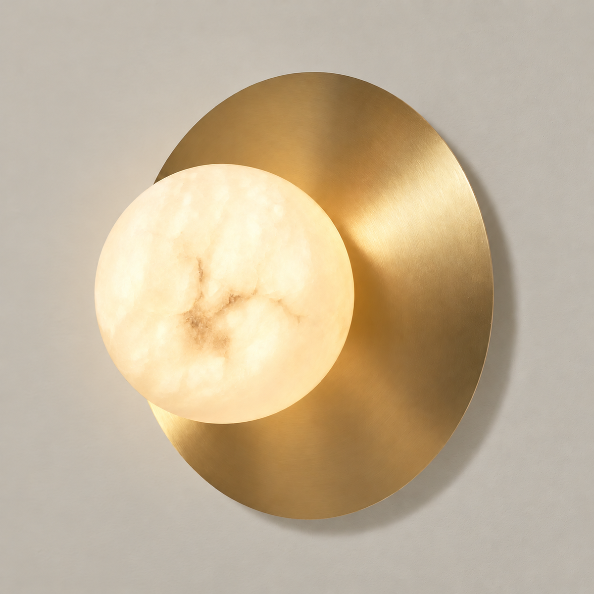Illuminated alabaster globe showing natural mineral clouds against its brass disc.
