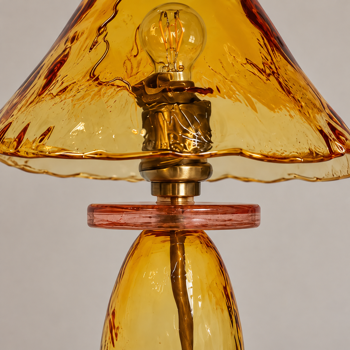 Wavy amber glass shade, pink collar and brass socket