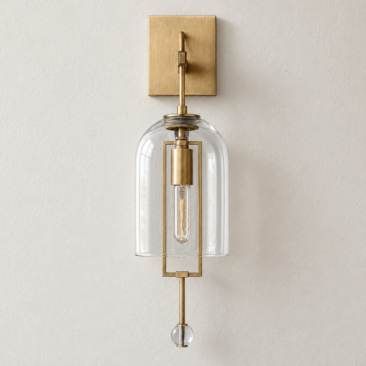 Brass wall sconce with an open-bottom glass bell and crystal finial, switched off on ivory plaster.