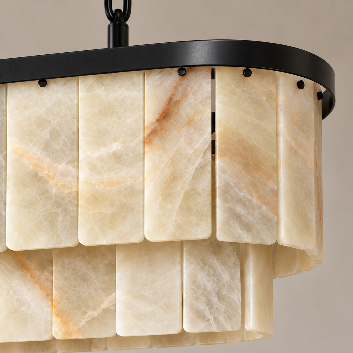 Honey onyx panels and black fittings at the rounded end of the linear chandelier.