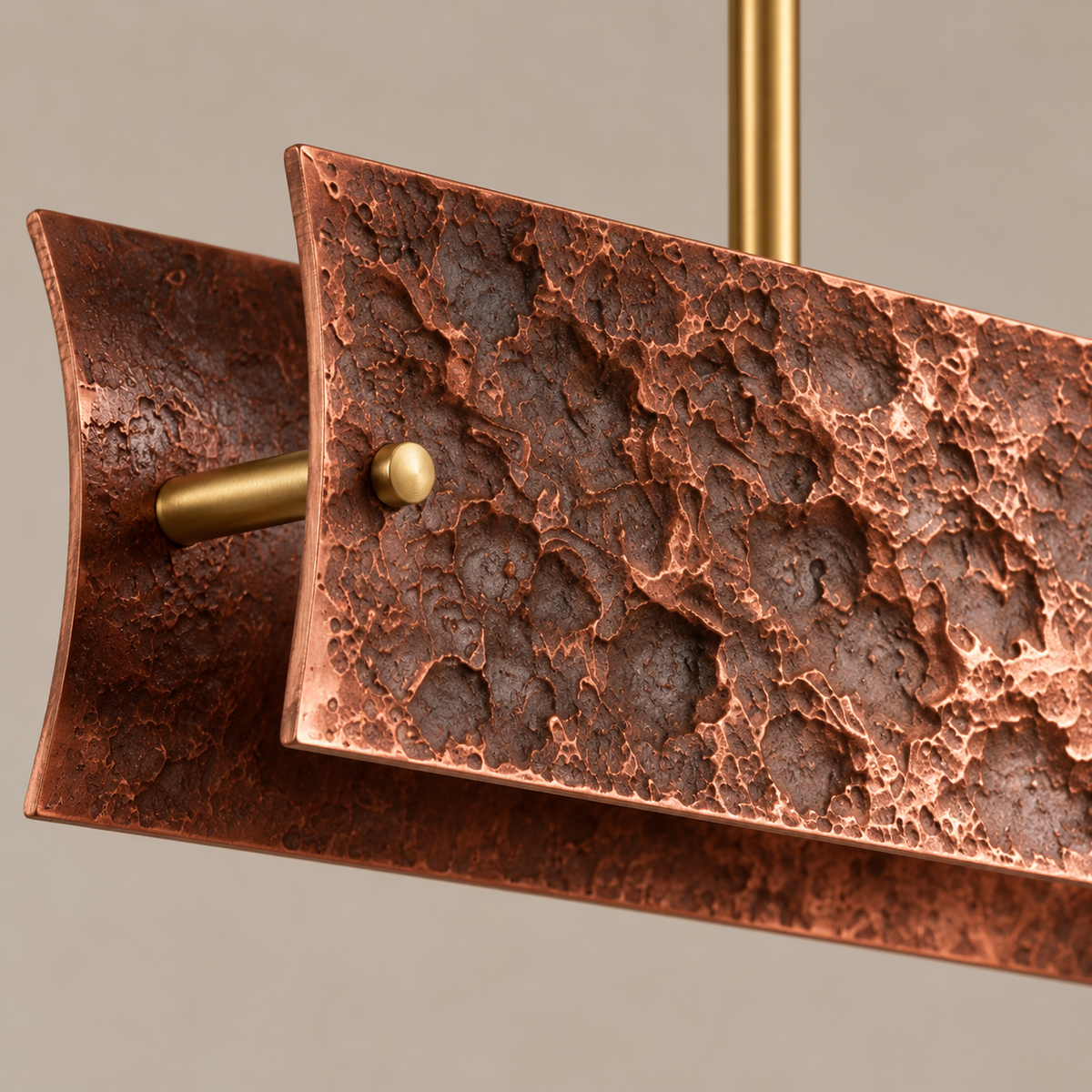 Close-up of Matera’s deep cast-copper relief and brass fixing