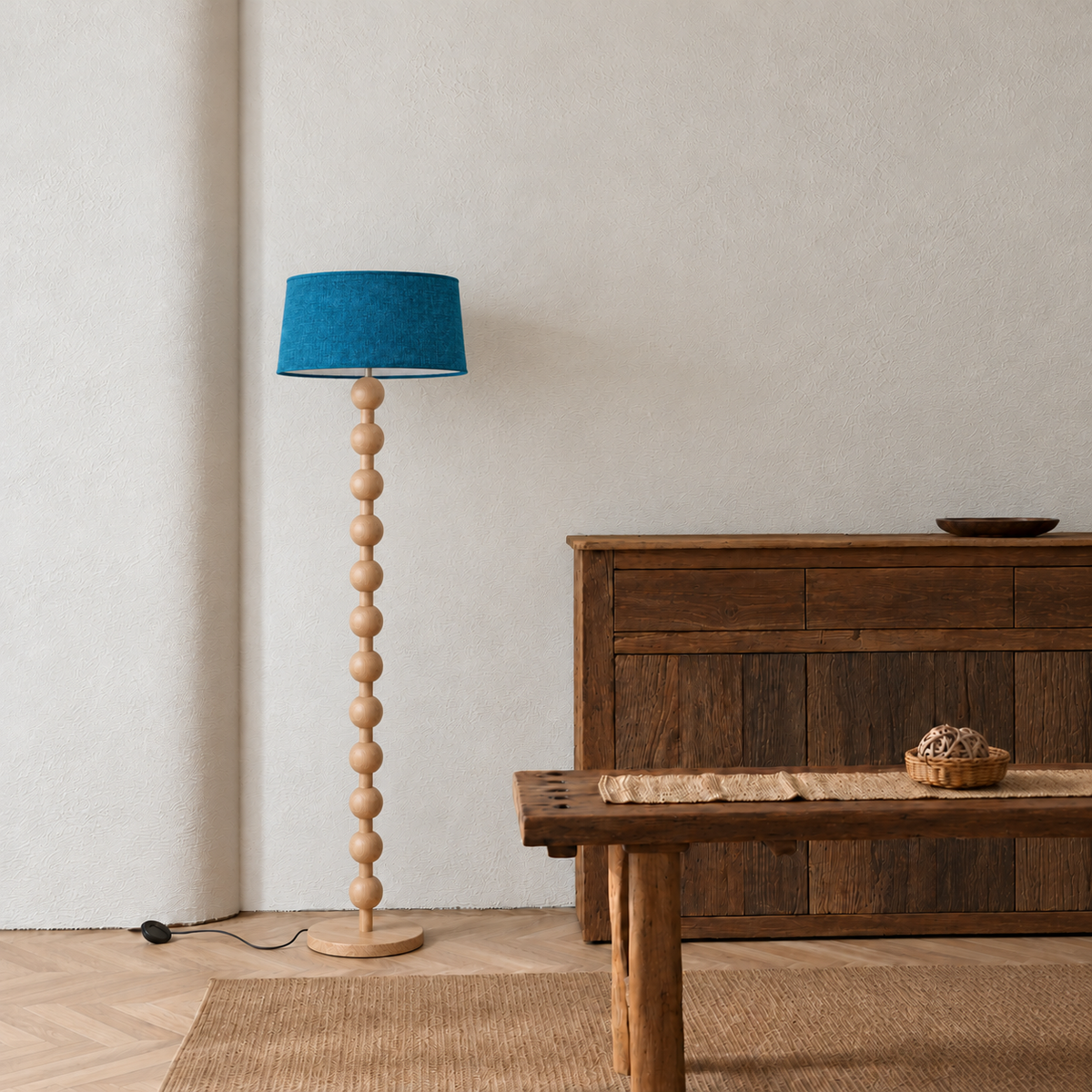 Sirmione Natural Wood Floor Lamp with petrol blue linen shade in a furnished room.