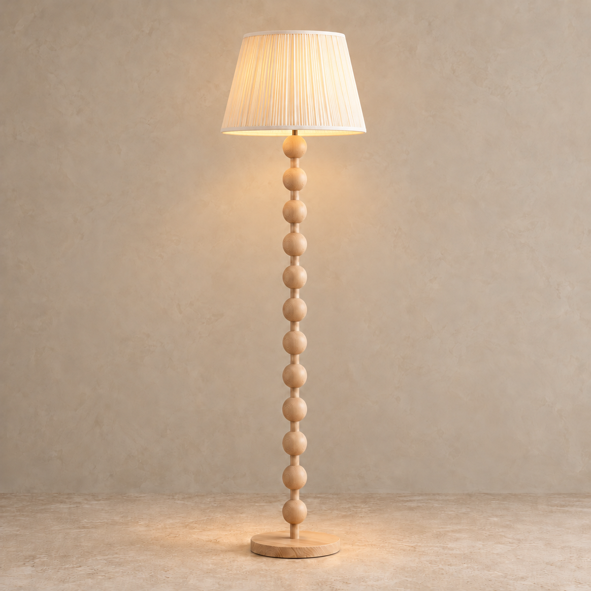 Sirmione Natural Wood Floor Lamp with cream fine pleated shade, illuminated in natural daylight.