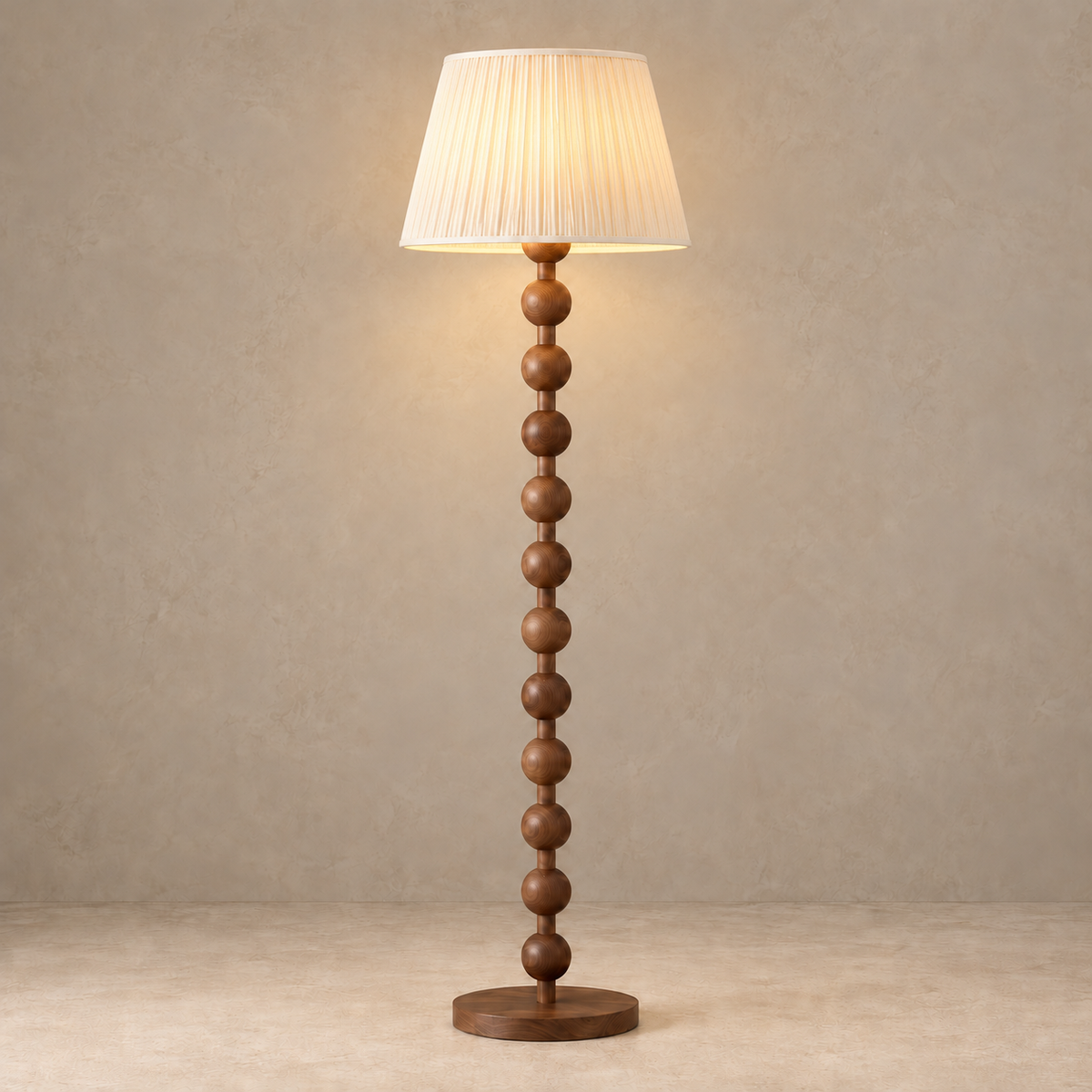 Sirmione Walnut Floor Lamp with cream fine pleated shade, illuminated in natural daylight.
