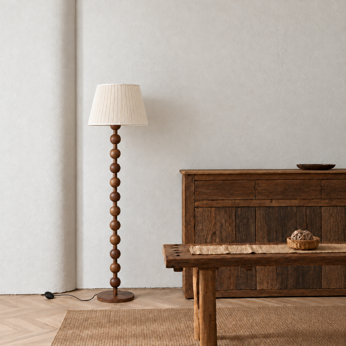 Sirmione Walnut Floor Lamp with cream fine pleated shade in a furnished room.