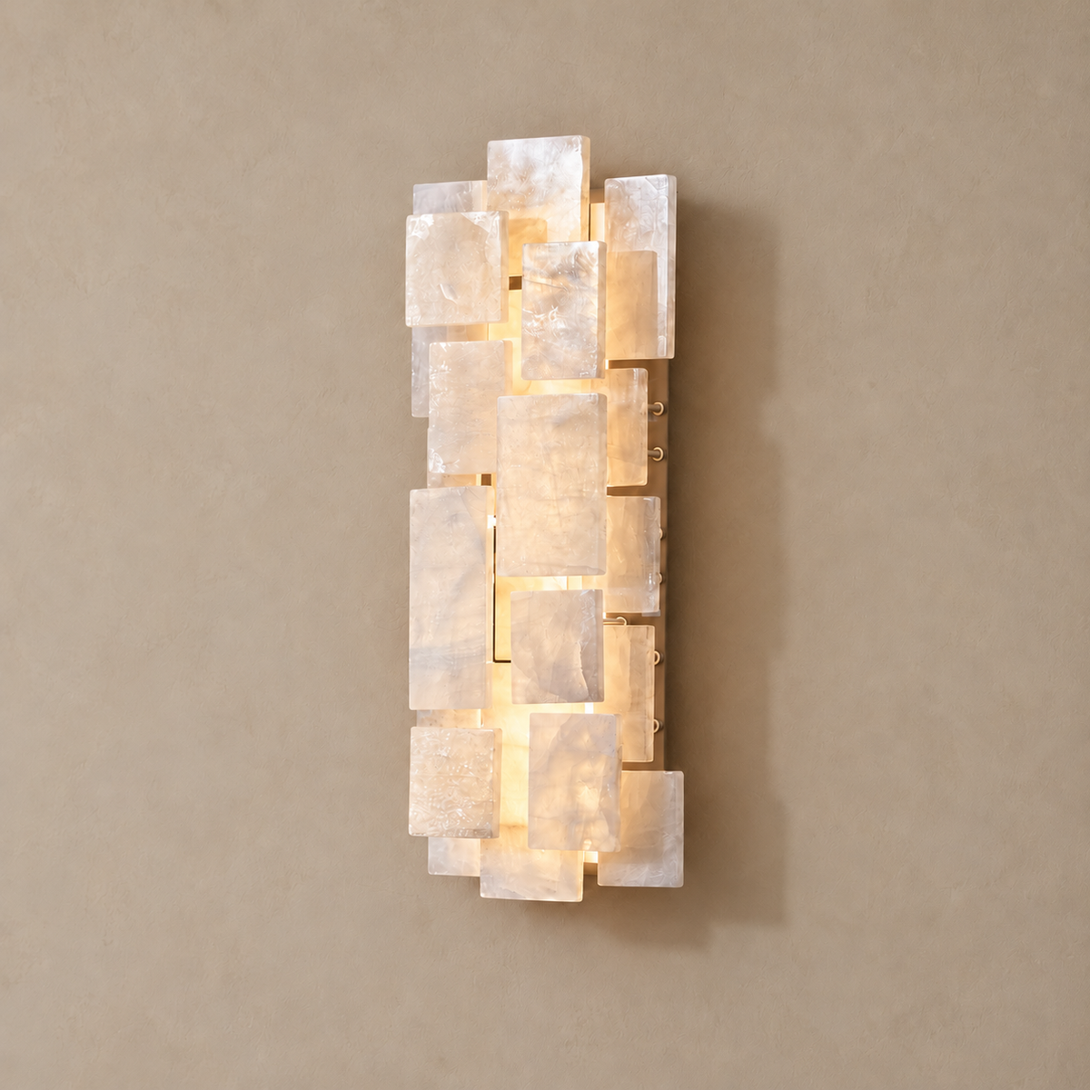 Marble and crystal wall sconce lit, with light glowing between the blocks.