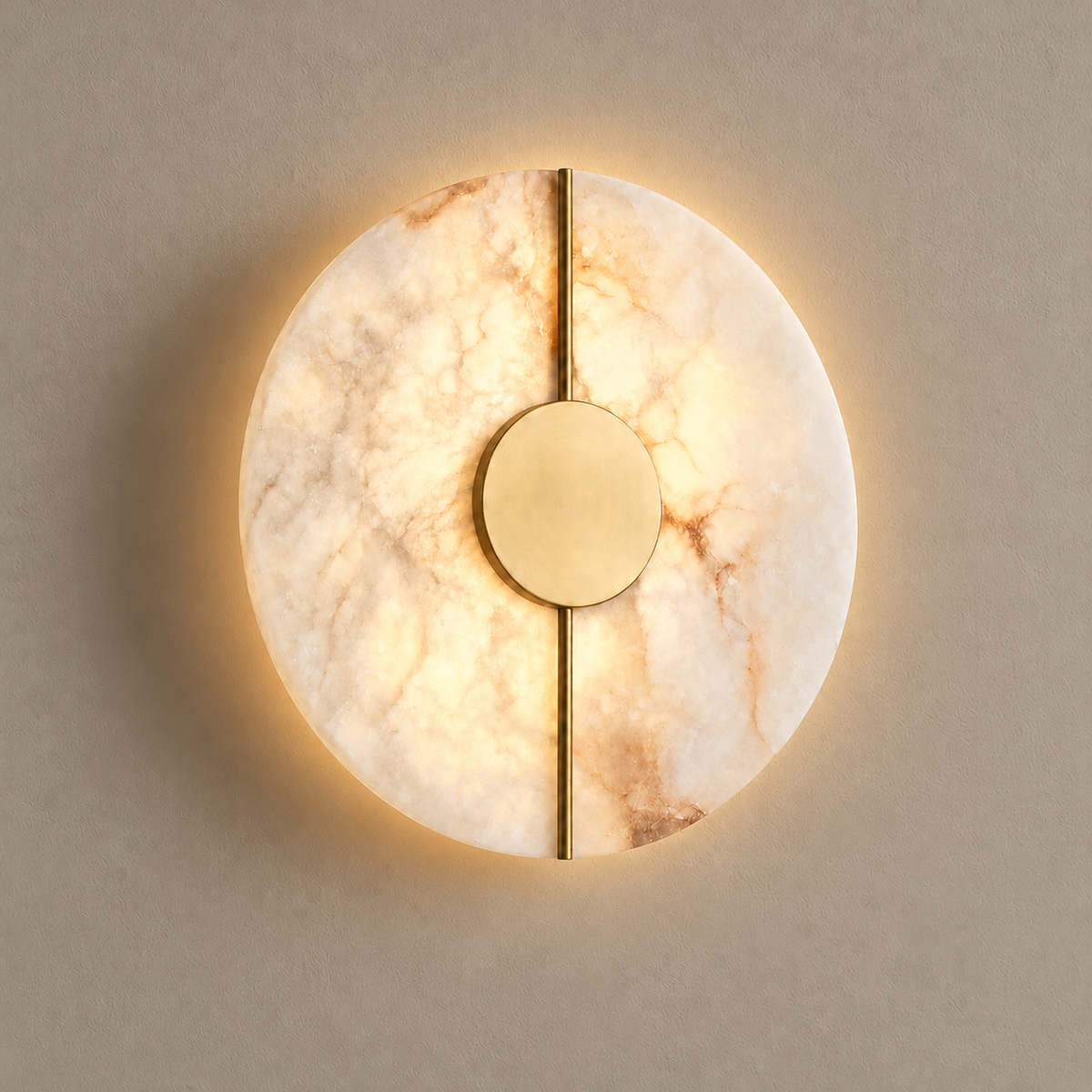 Marble and brass wall light, illuminated on a stone-beige wall