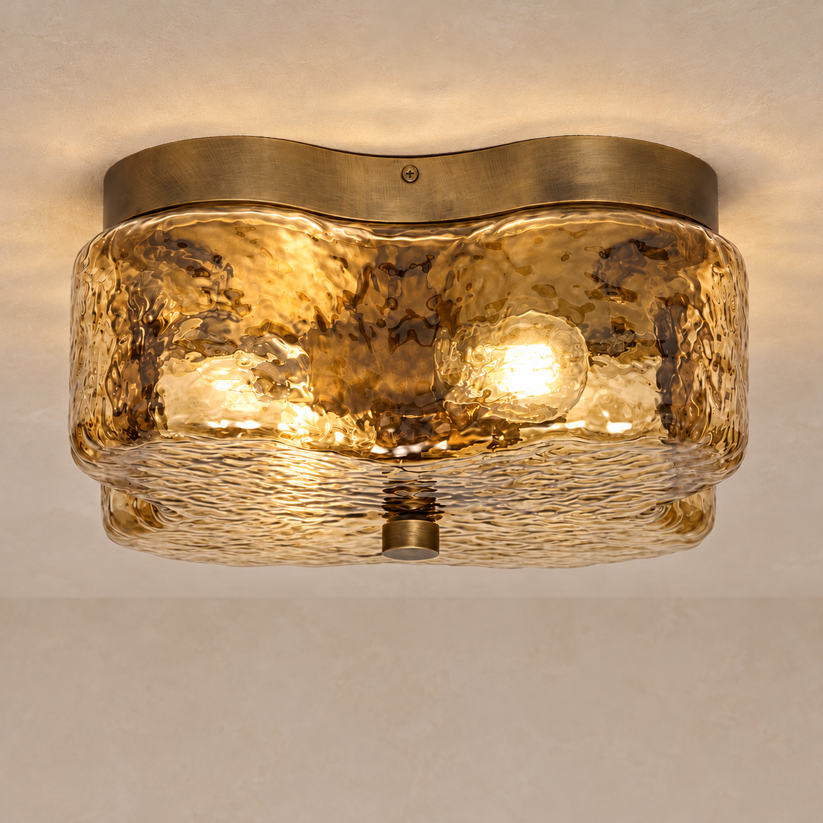 Amber glass flush mount illuminated, showing light through its rippled quatrefoil shade.