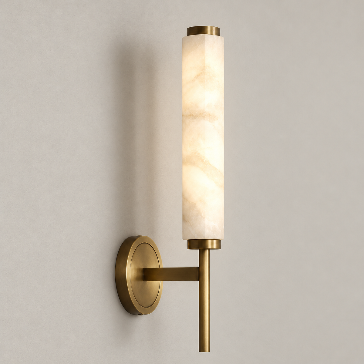 Alabaster cylinder wall sconce illuminated through its natural stone.