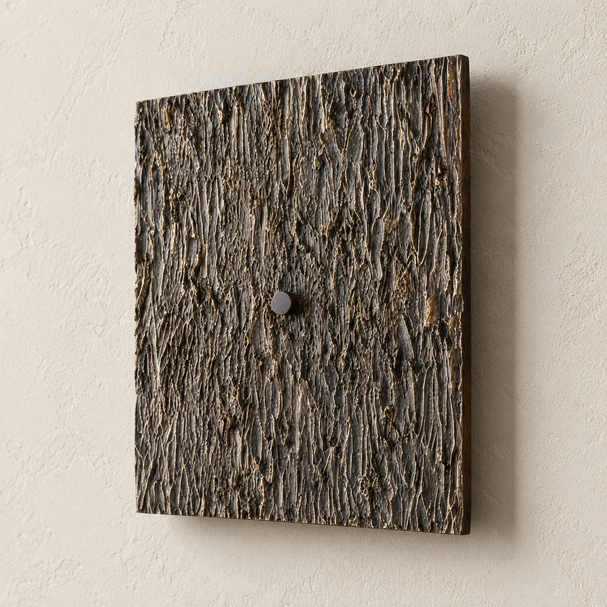Close-up of the dark Ratera sconce’s bark-like cast-metal relief and central cap.