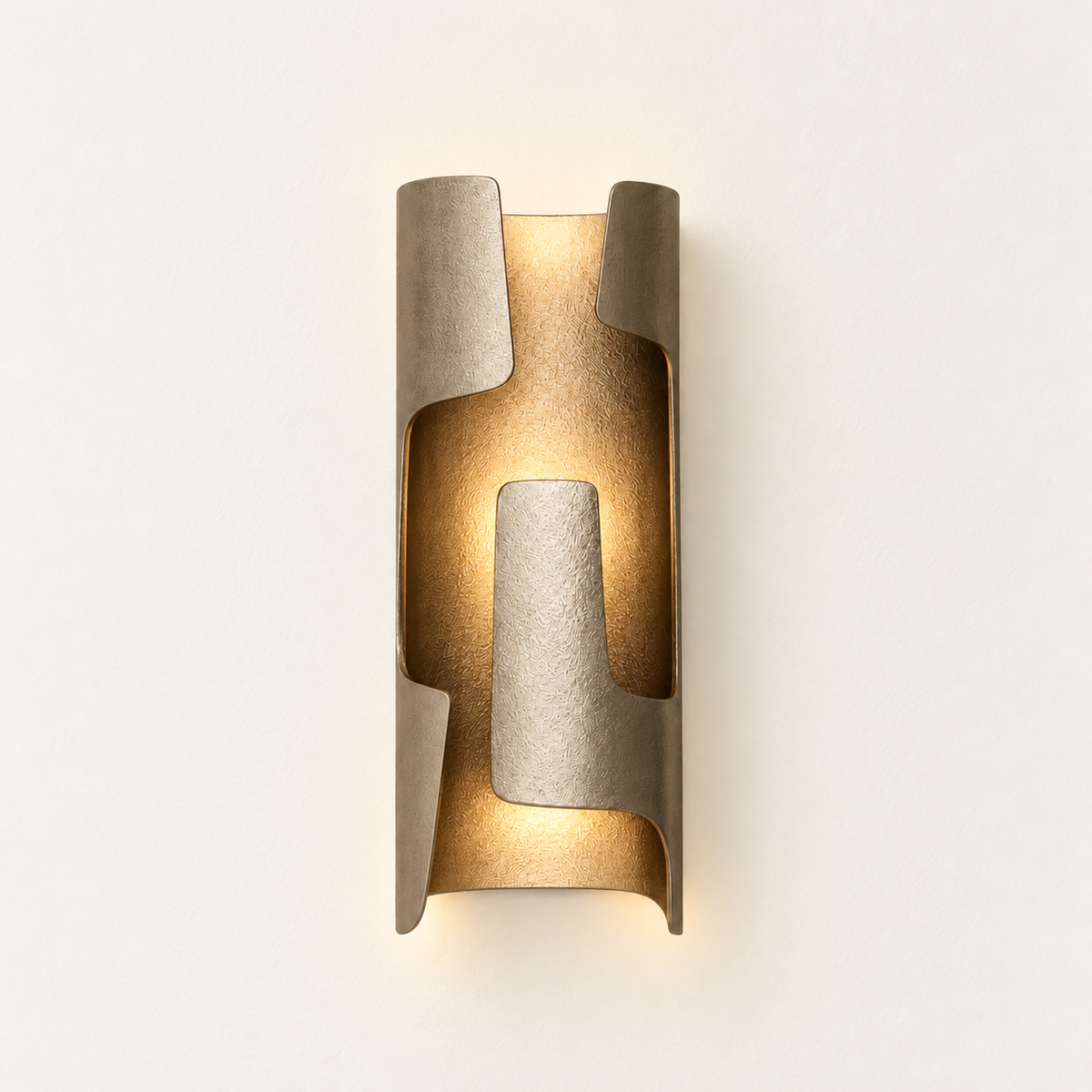 Illuminated champagne bronze-finish wall sconce with overlapping curved metal panels, viewed from the front.