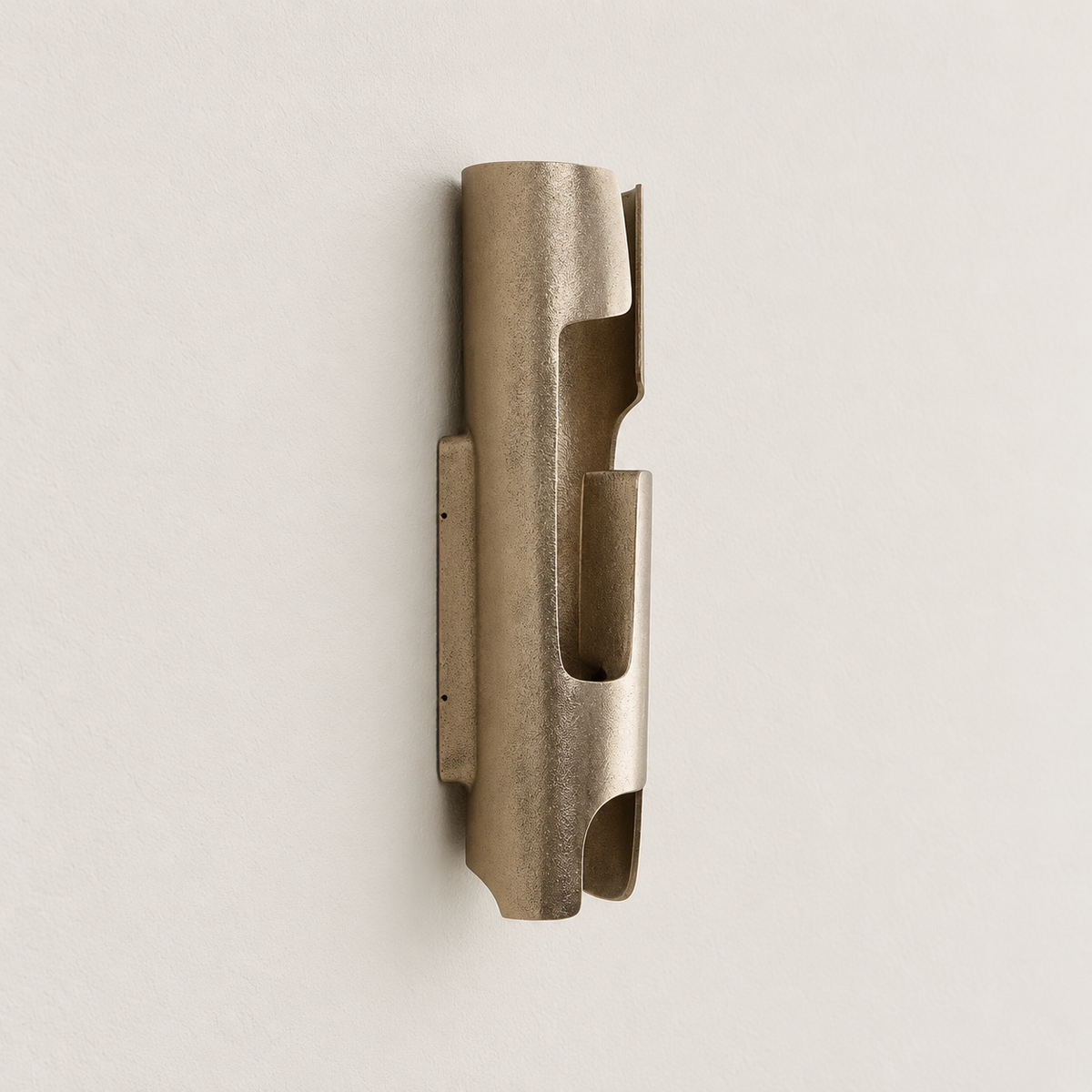Side view of the champagne bronze-finish sconce showing its folded panels and shallow wall backplate.
