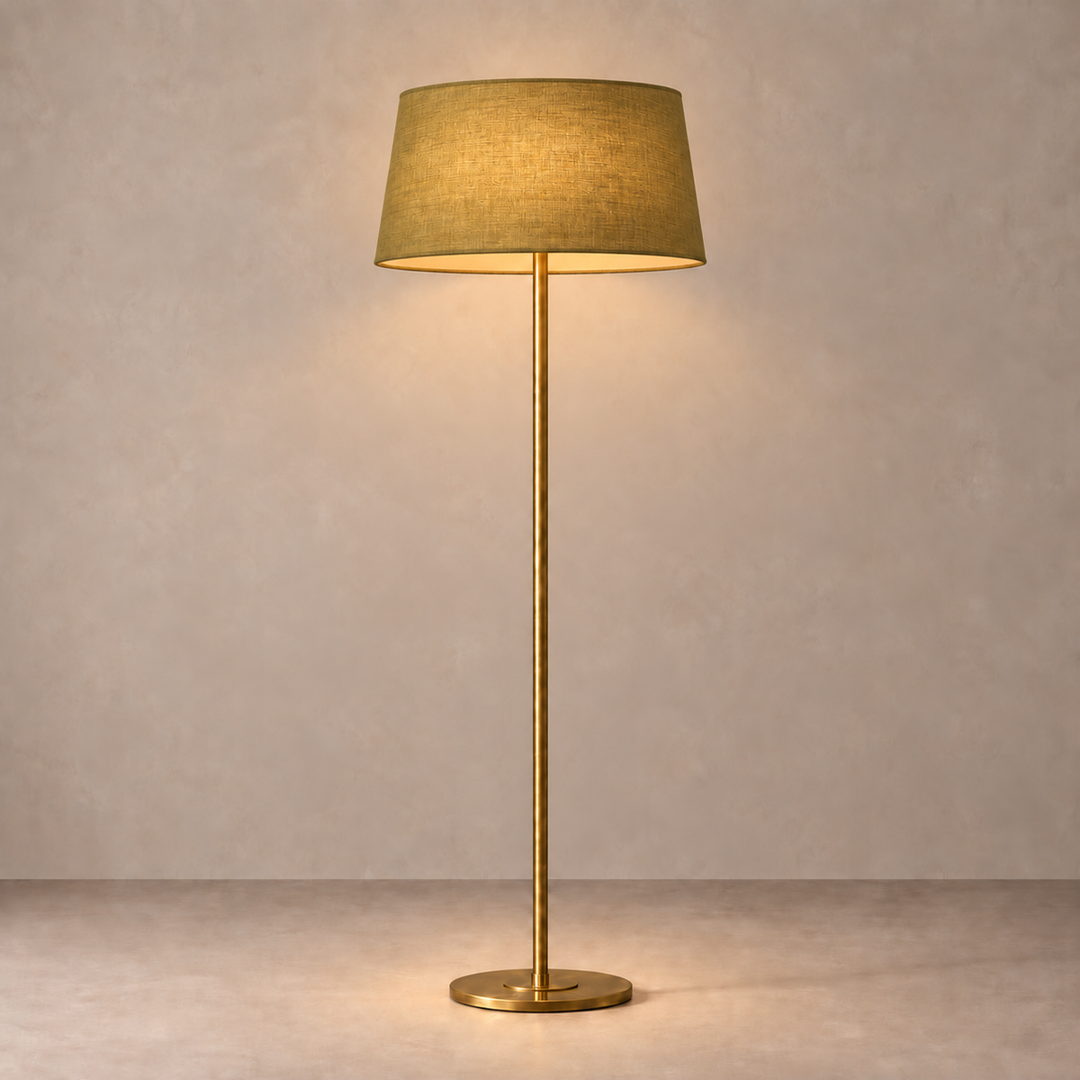 Brushed Brass Floor Lamp with olive linen shade, illuminated in natural daylight.