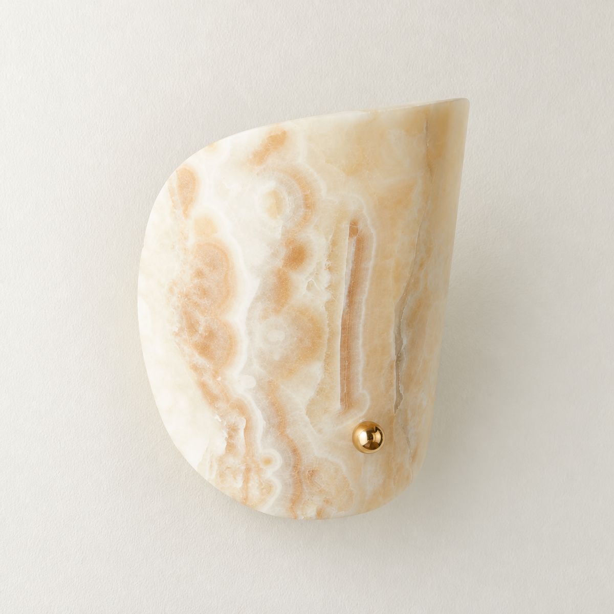 Unlit jade curved wall sconce mounted on warm ivory.