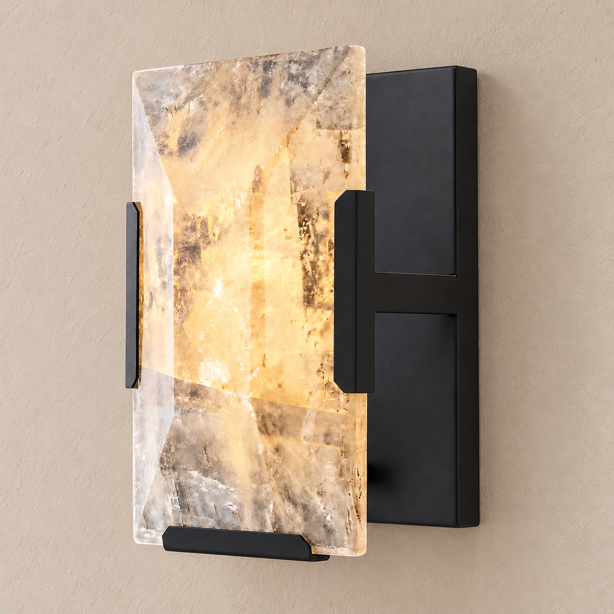 Calcite wall sconce with black hardware, illuminated through the natural stone.