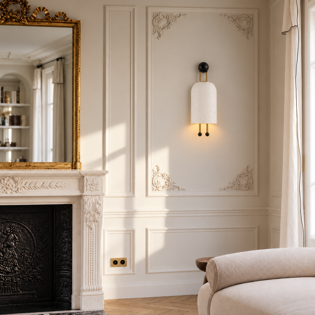 Verona matte ceramic and brass wall sconce installed beside a fireplace in a Parisian living room.