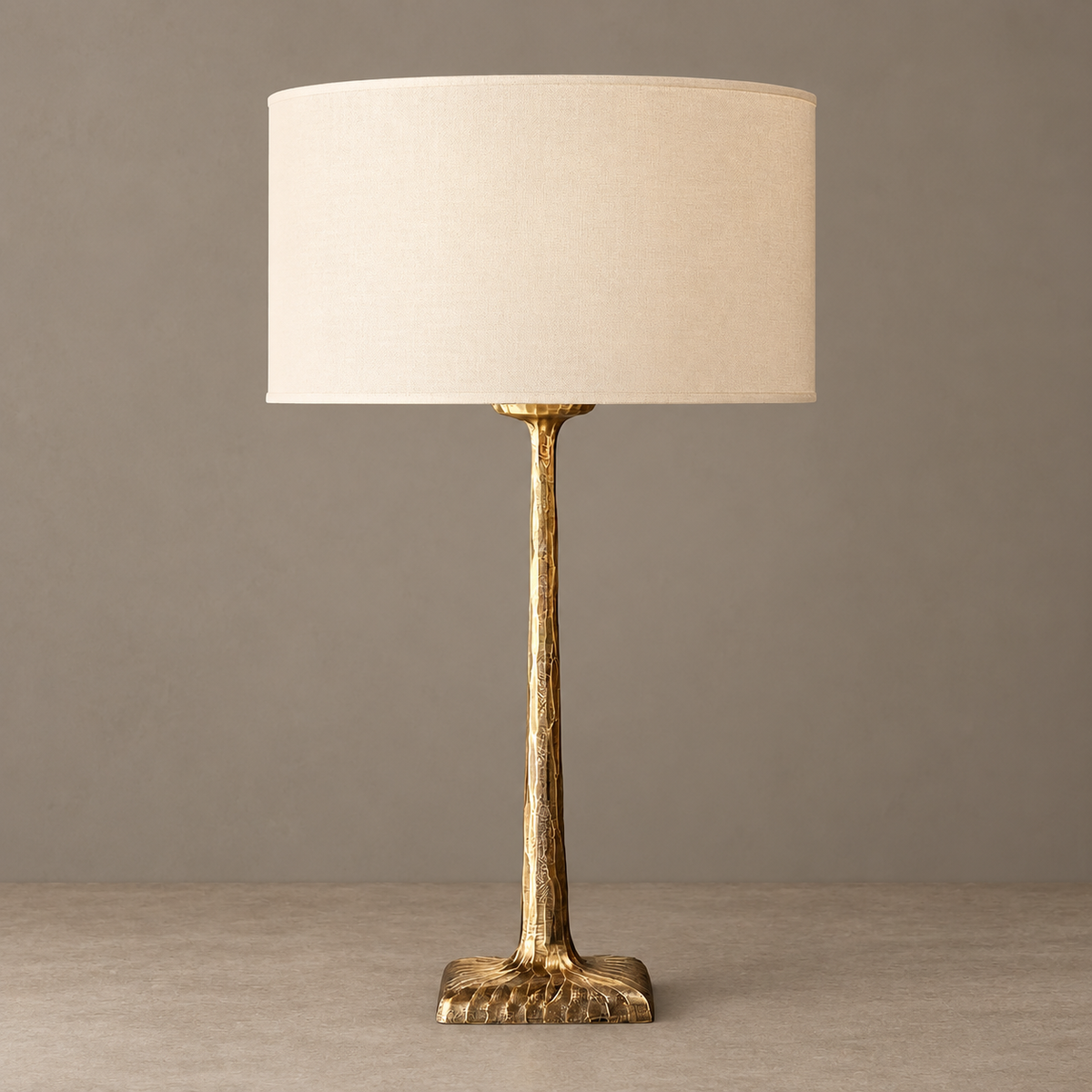 Unlit hammered copper lamp with a cream drum shade.