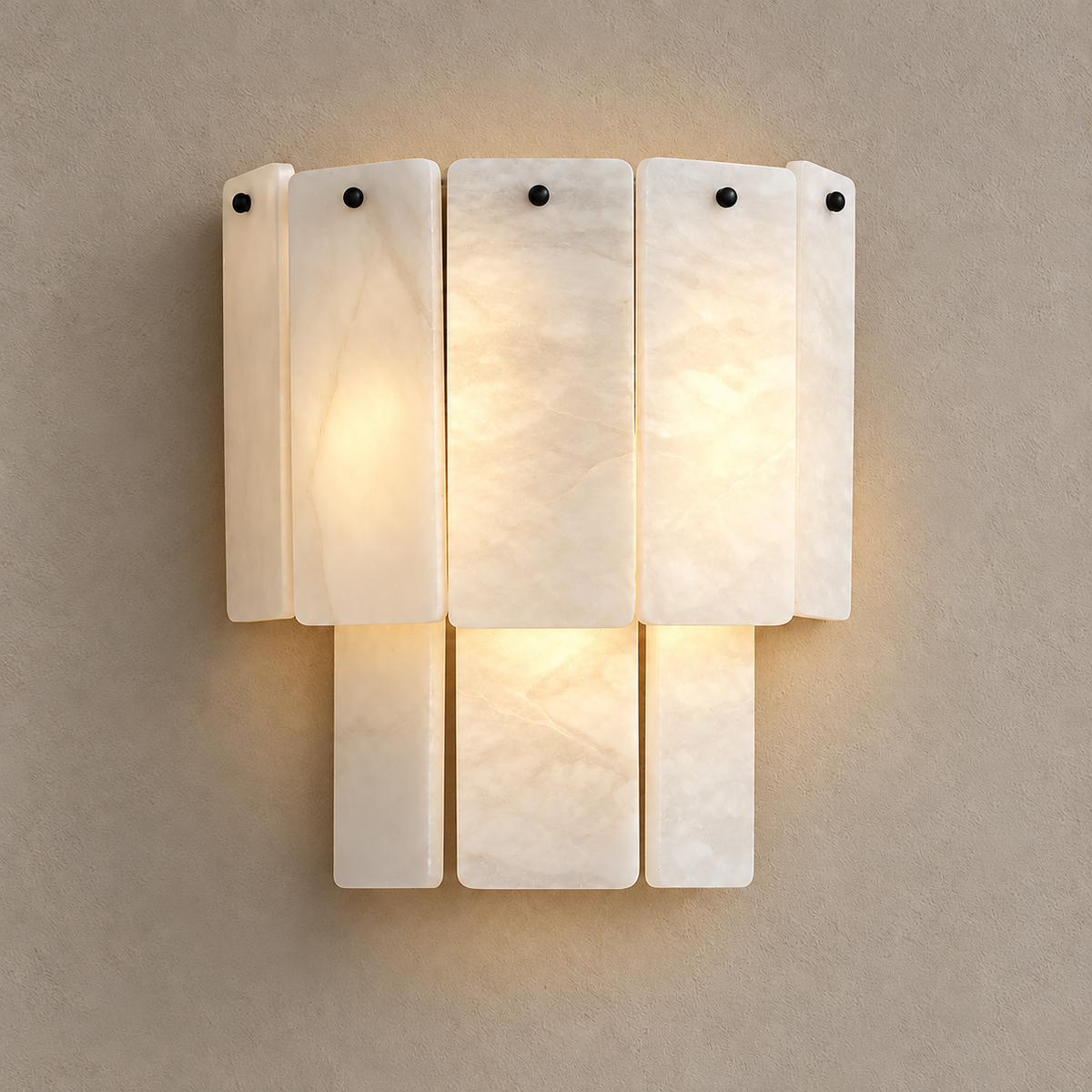 Walter wall sconce illuminated through its layered alabaster panels.