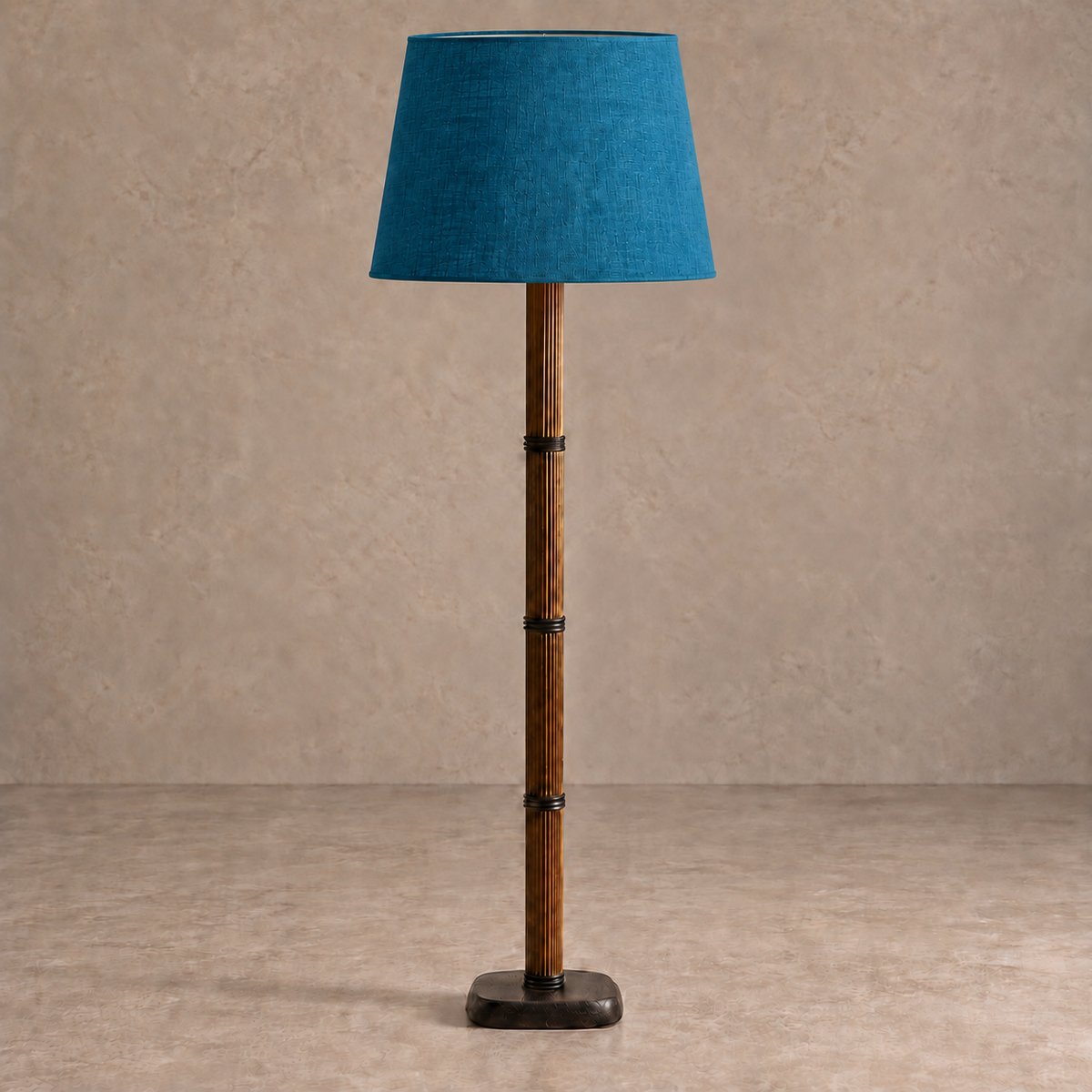 Galerie Fluted Column Floor Lamp with petrol blue linen shade, unlit against a stone-beige background.