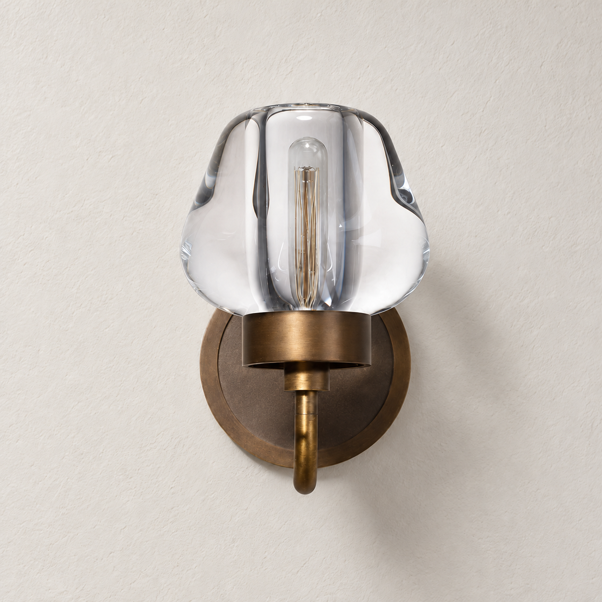 Front view of the brass and hand-formed crystal wall sconce, switched off.