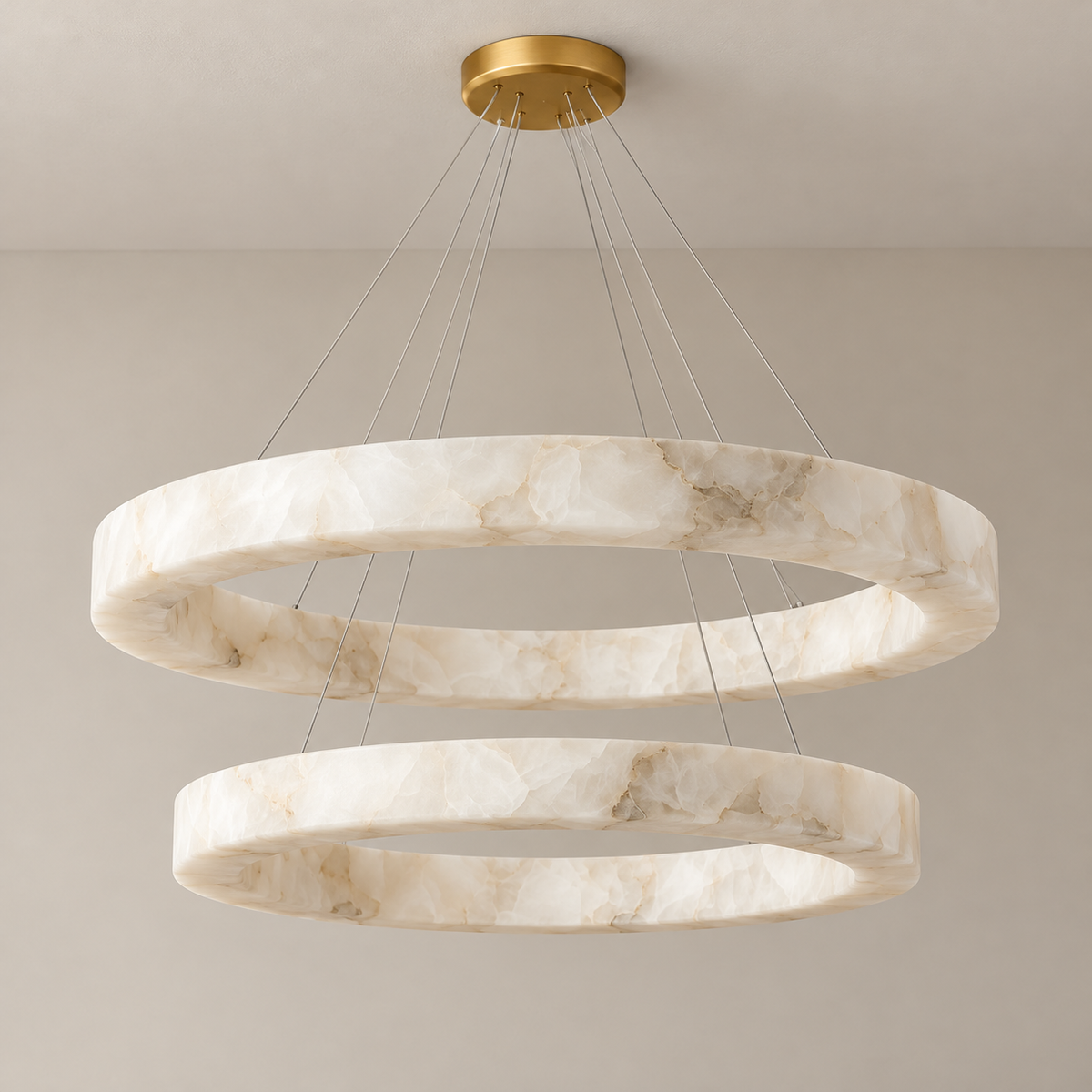 Double alabaster ring chandelier with gold canopy and fine suspension cables, unlit.