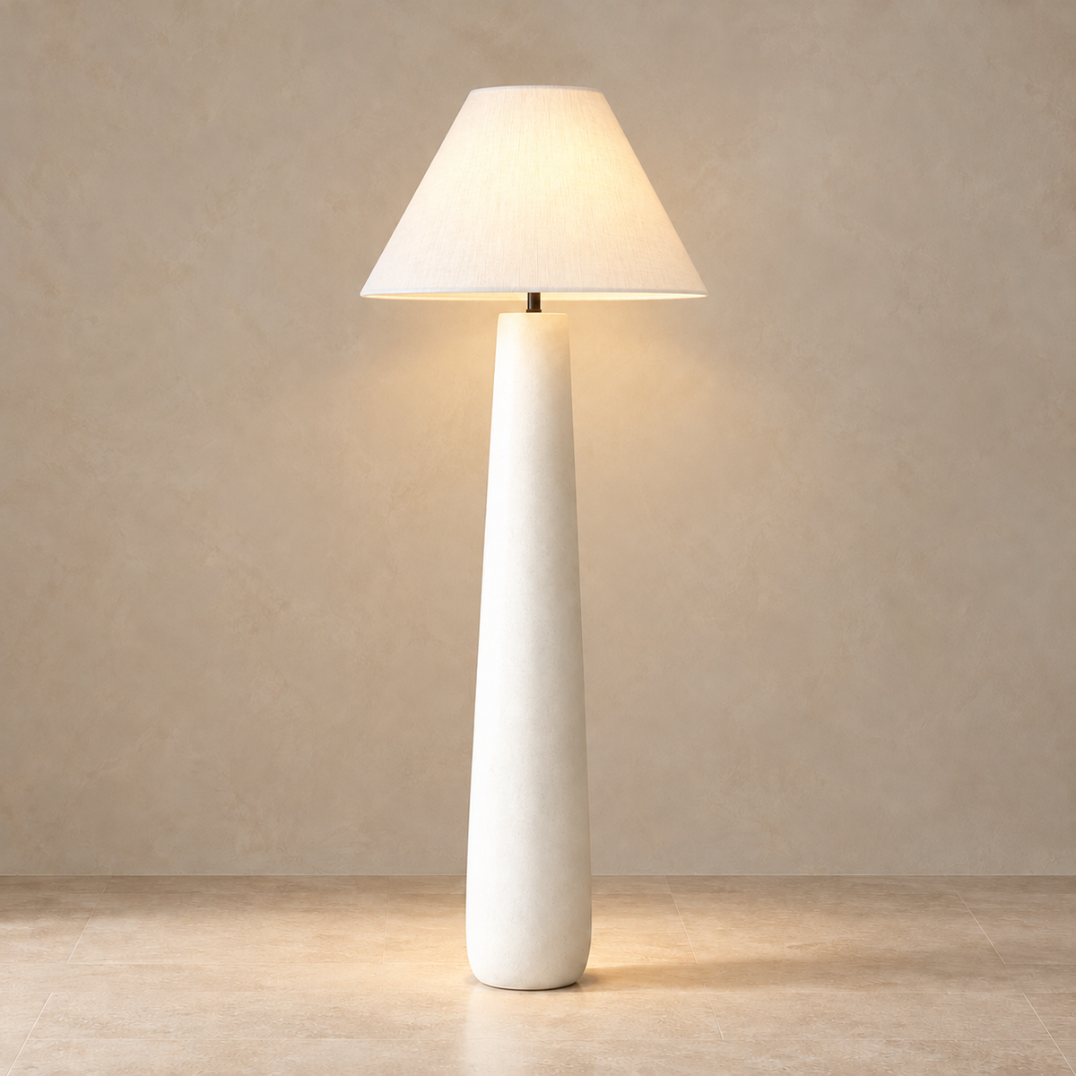 White Fungo Bianco floor lamp illuminated through its fabric shade.