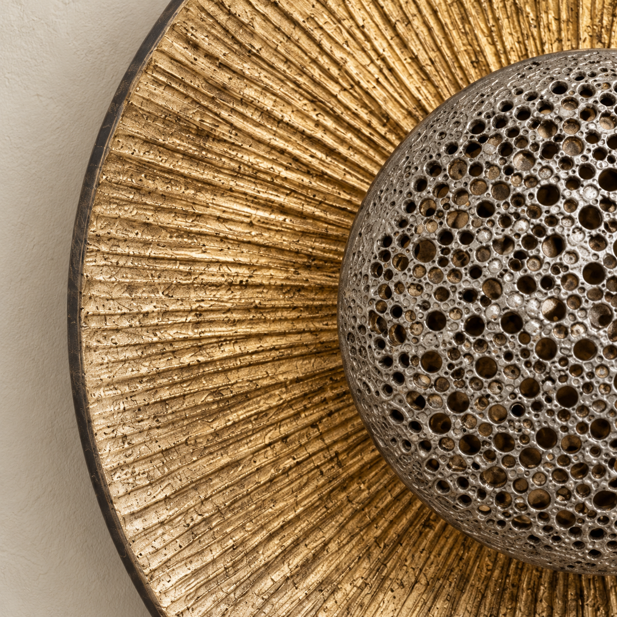 Close view of the radial gold texture and perforated metal dome.