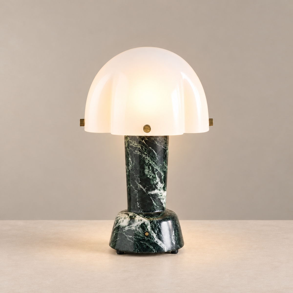 Green Marble Table Lamp, illuminated, on a beige background.
