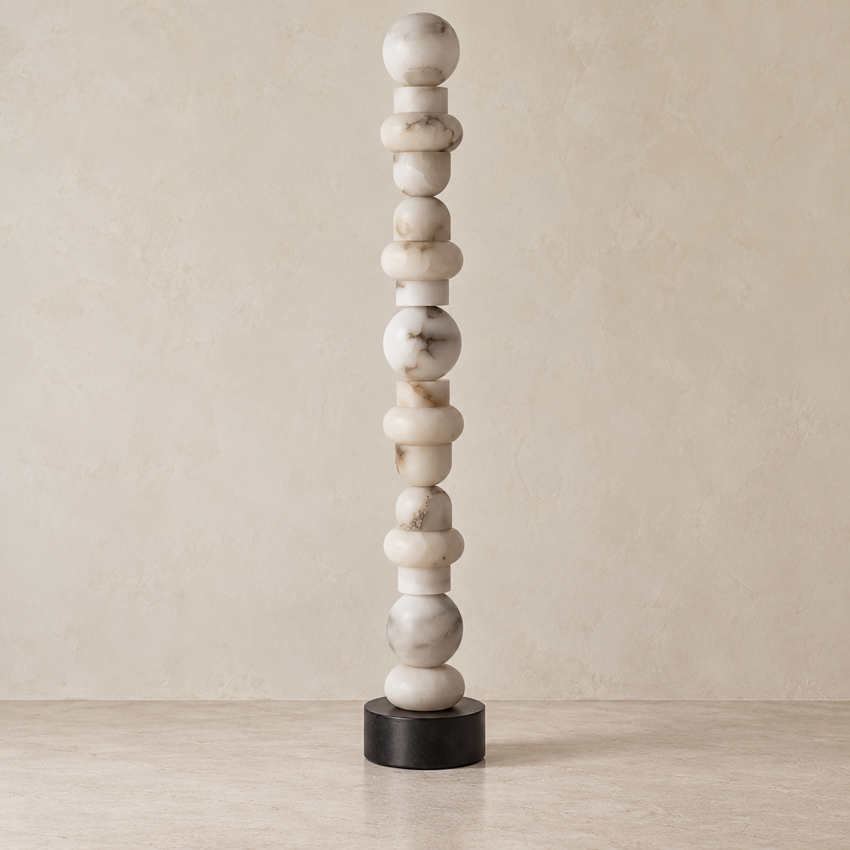 Grenaldi alabaster column floor lamp with natural mineral markings and a black marble base, switched off.