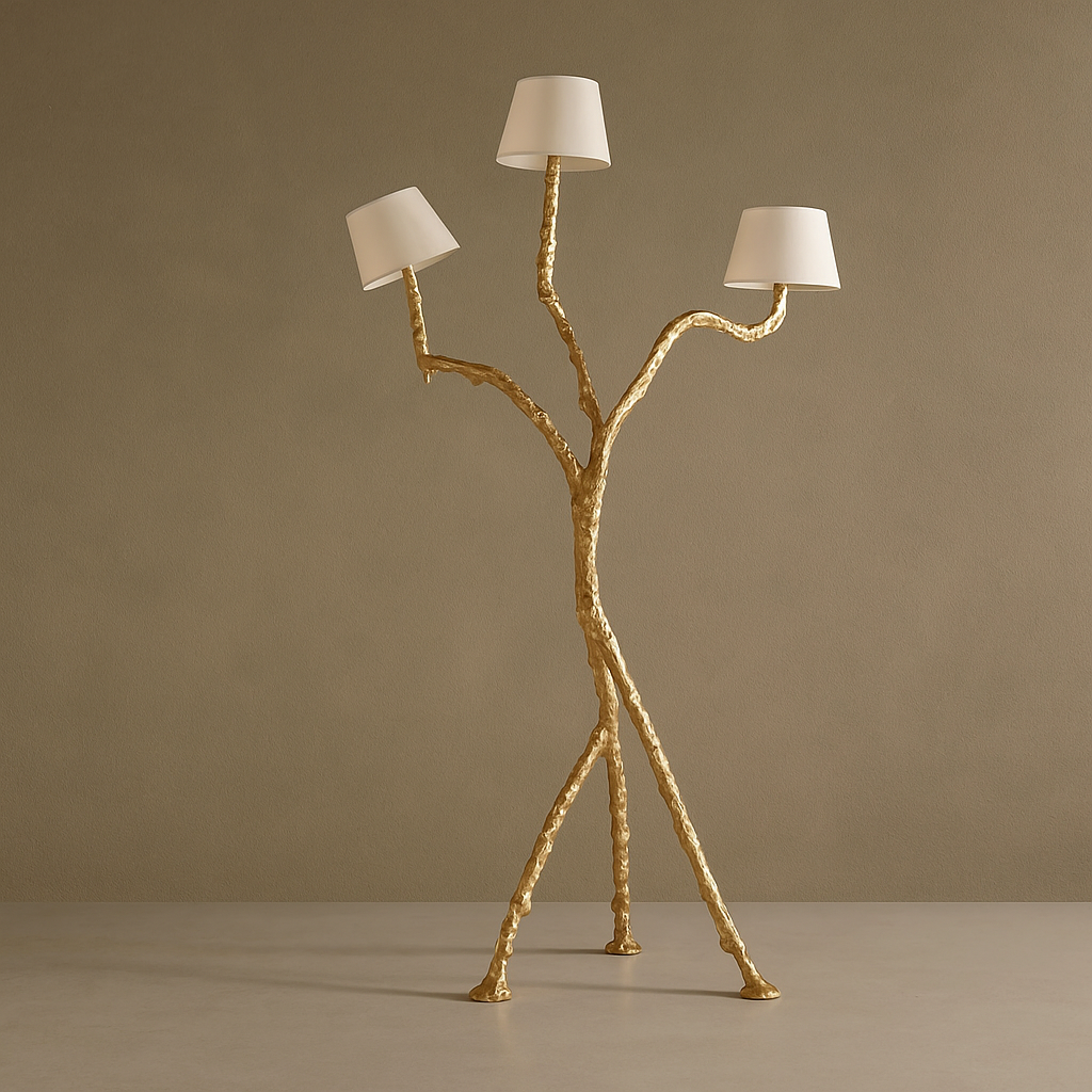Gold floor lamp with three white lampshades on a beige background