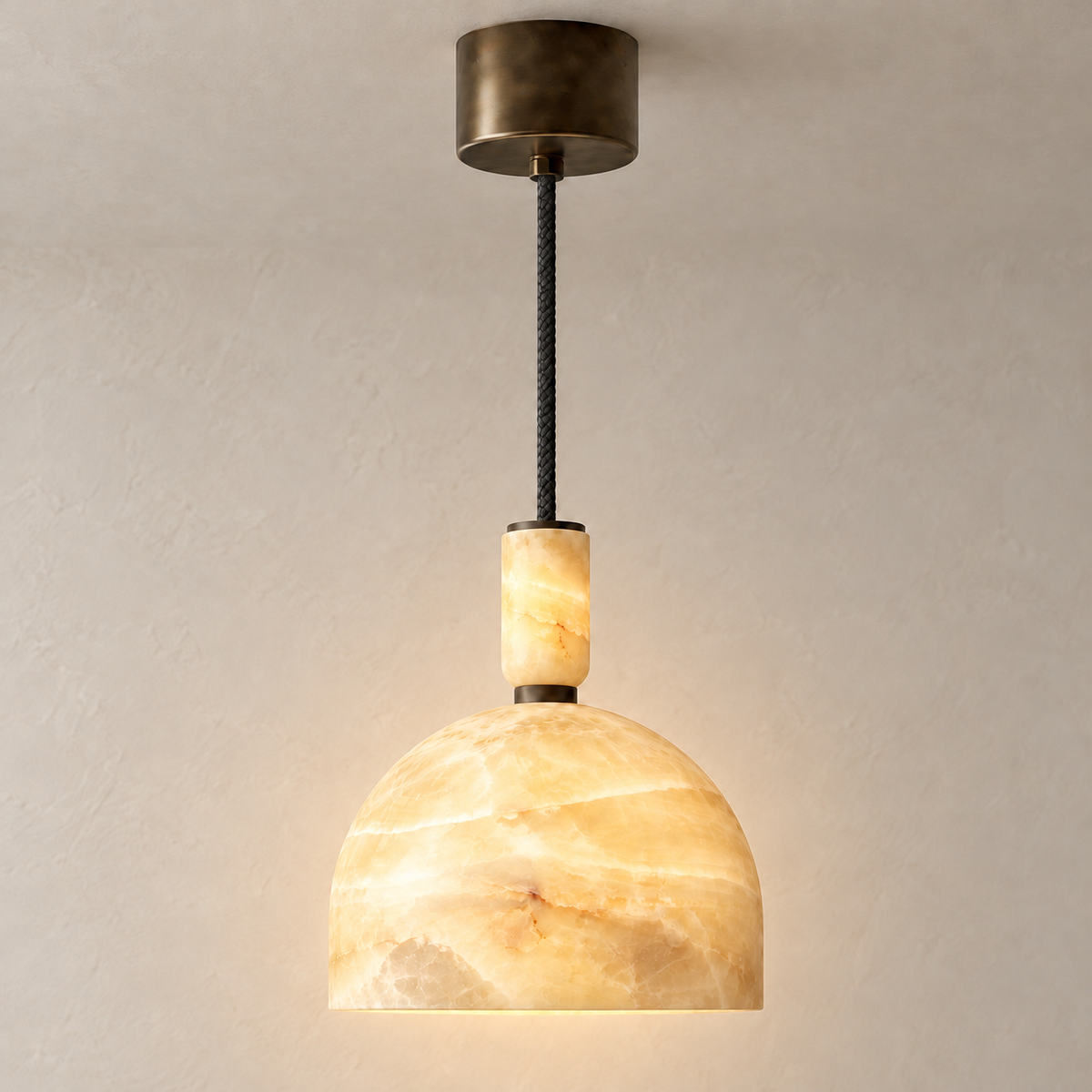 14 cm honey onyx dome pendant with a dark-bronze ceiling rose, illuminated.