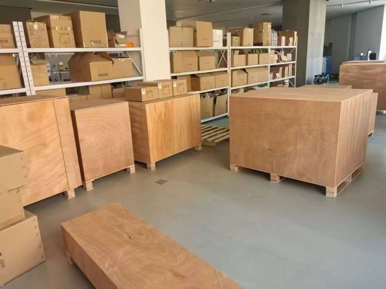 Light brown wooden crates stacked on pallets in a warehouse.