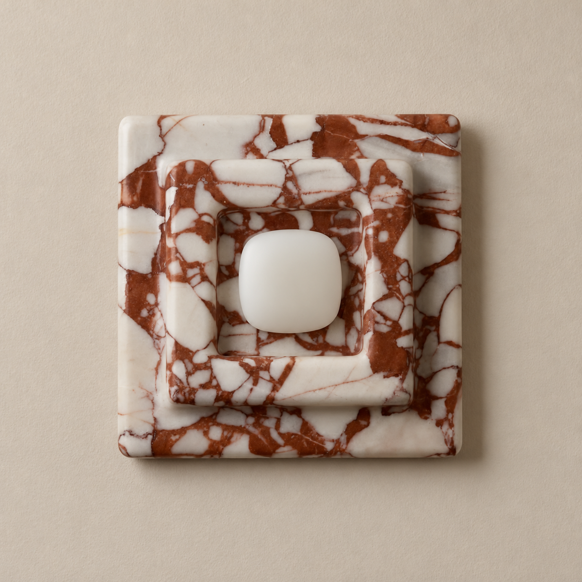 Red marble square wall sconce, switched off on a beige wall.