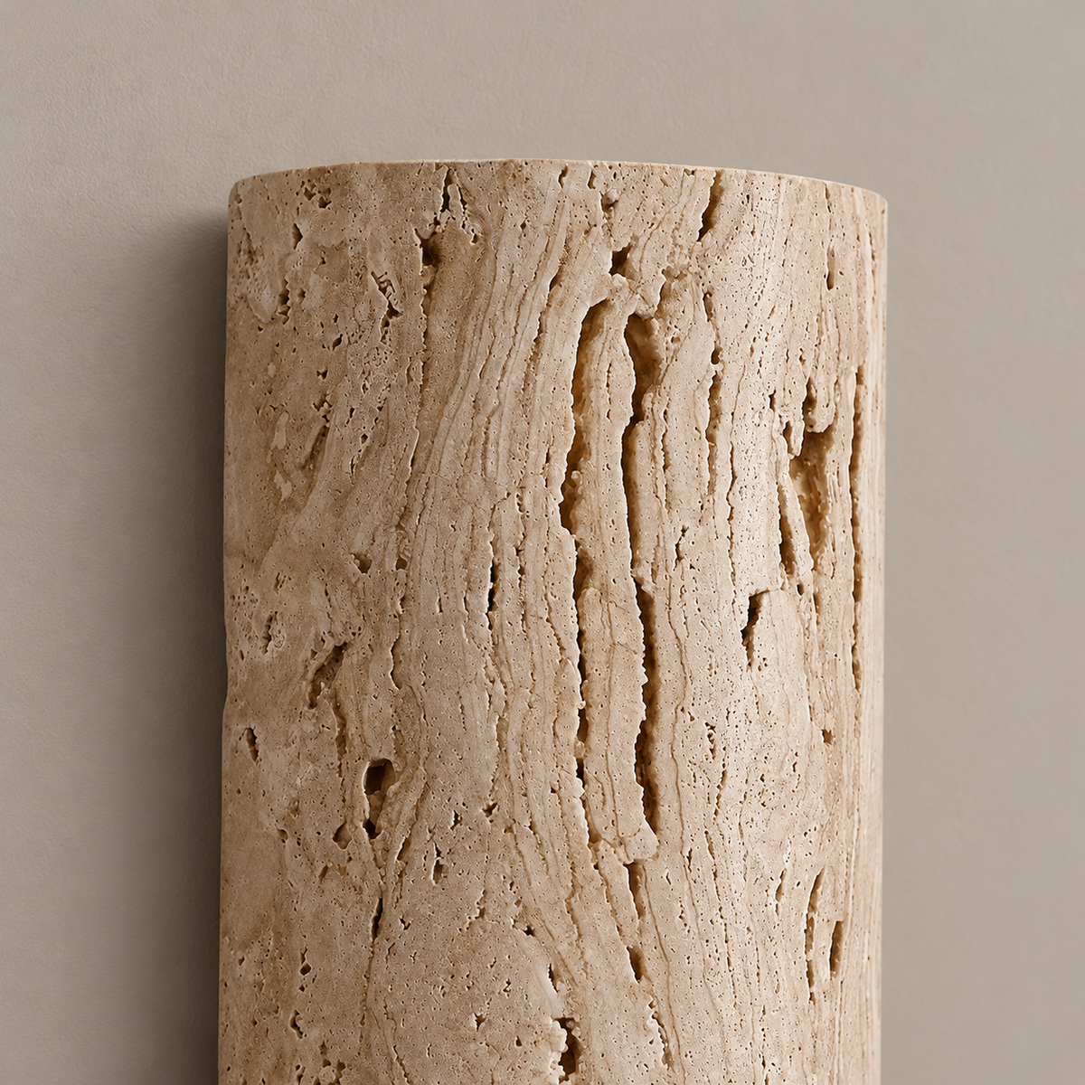 Close view of the curved natural travertine face and open pores.