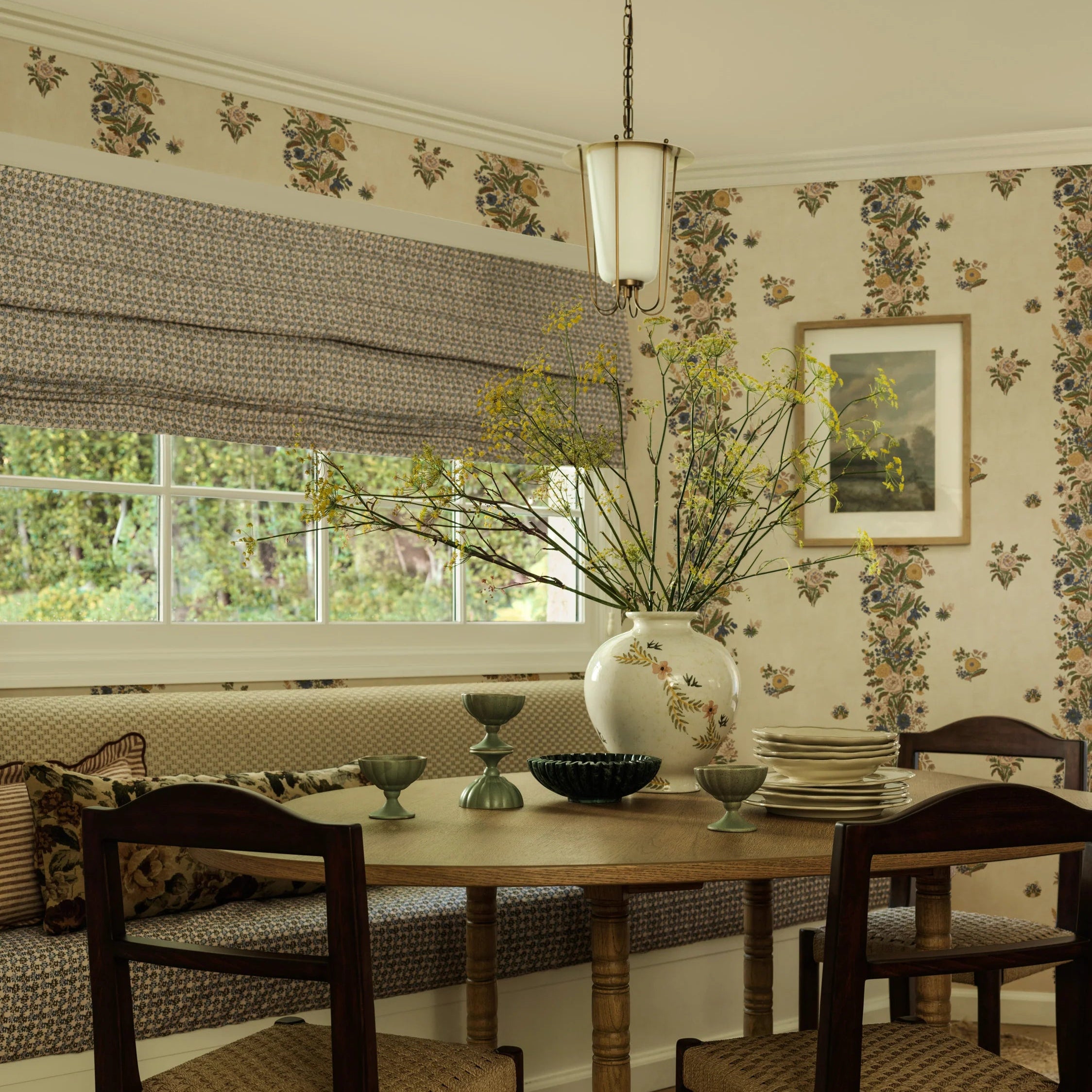 Dining room with wooden table and chairs, floral wallpaper, and a window with blinds.